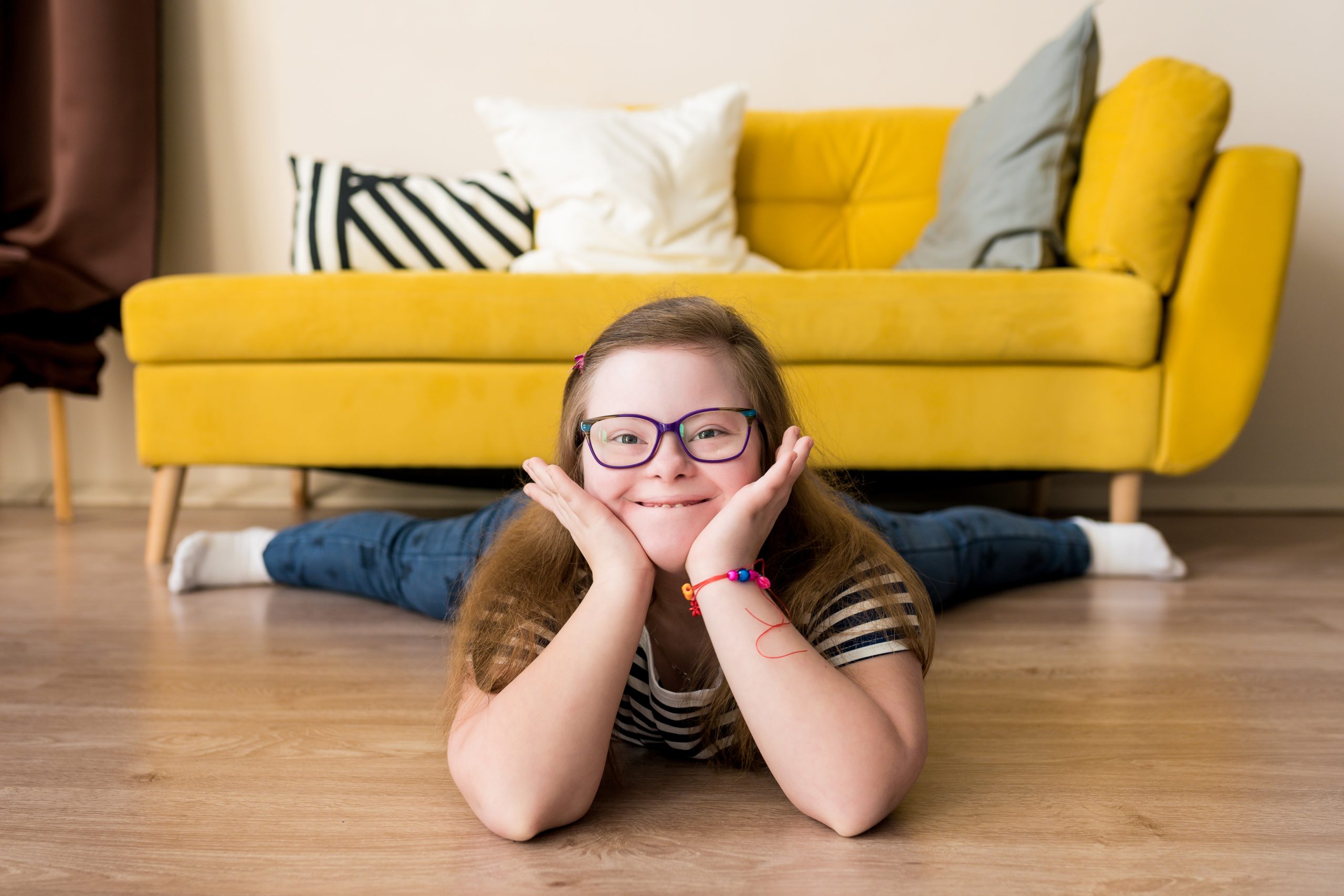Portrait,Of,Smiling,Teenager,Girl,With,Down,Syndrome,Lying,On Portrait,Of,Smiling,Teenager,Girl,With,Down,Syndrome,Lying,On